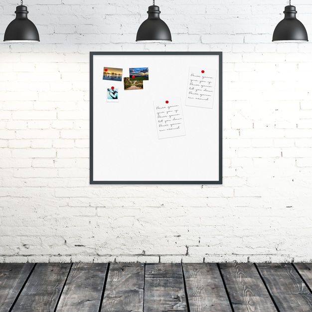 Weiße Design Whiteboard mit schwarzem Rahmen an einer weißen Ziegelwand